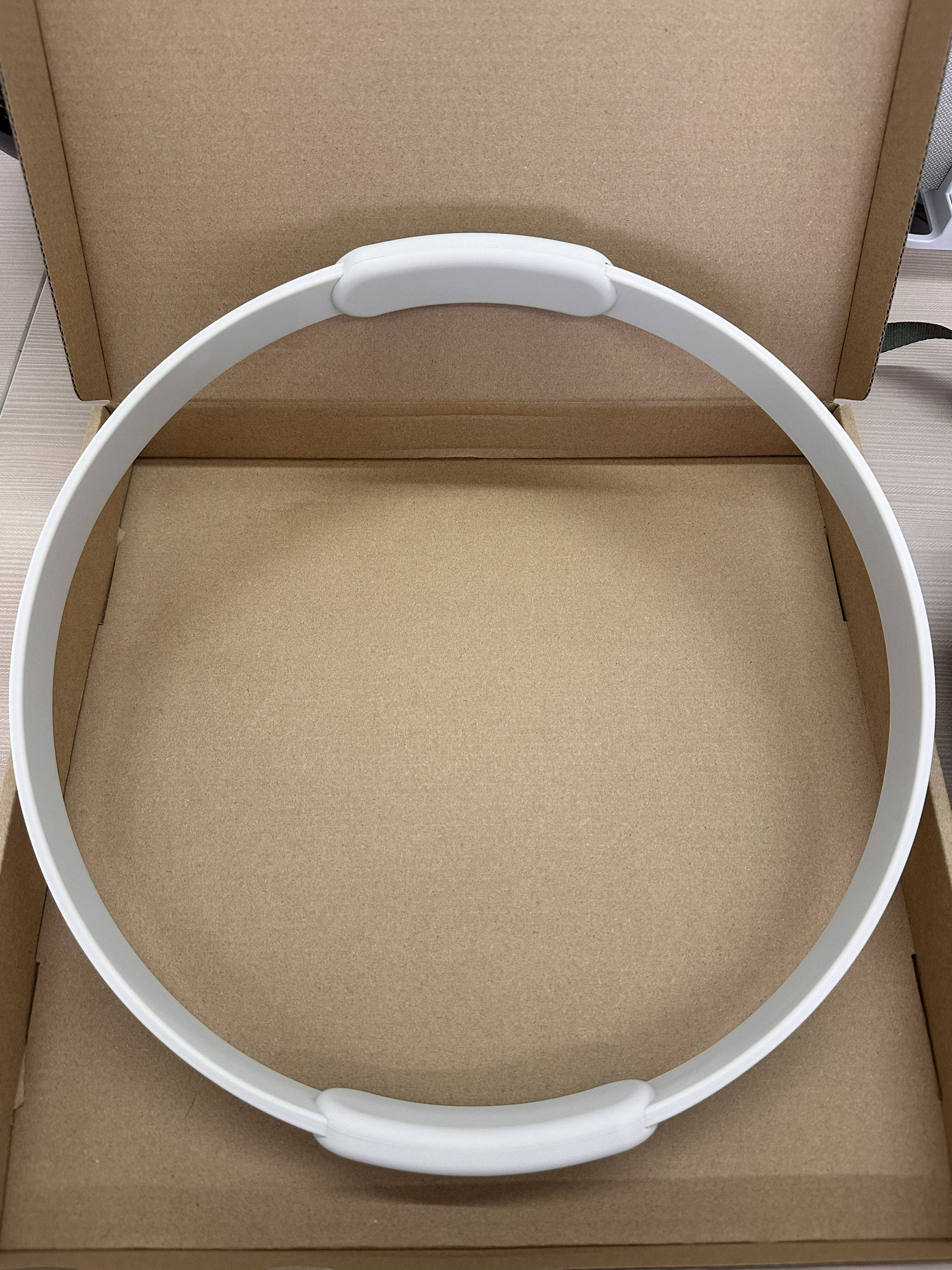 Silicone Pilates ring inside a kraft paper box